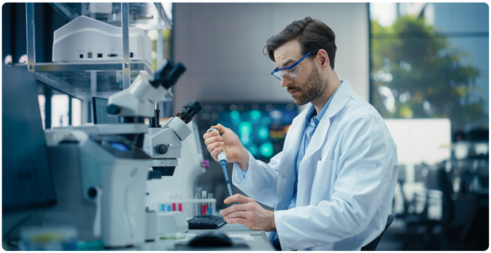 Photo of a man working with a DNA/RNA synthesizer